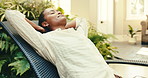 Relax, happy and woman at hotel on chair for break, rest and chill on holiday, getaway or retreat. Hospitality, stretching and person with calm, zen and good mood for vacation, weekend and wellness
