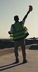 Celebrate, fist pump and man with helmet for construction, building approval and success on rooftop. Excited, back and person with ppe for compliance report, feedback and good news for engineering