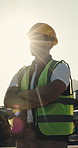Construction, thinking and person outdoor with helmet for evaluation, planning and building project. Architecture, flare and worker with idea for remodeling, property development and crossed arms