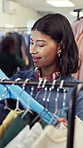 Shopping, choice or woman at clothes rack for boutique sale, garment option or happy with quality. Decision, customer or browse rail for fashion style, wardrobe update or perfect size in deal hunting