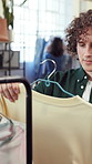Shopping, choice or man at clothes rack for boutique sale, garment option or satisfied with quality. Display rail, shopper or decision for fashion style, thrifting or perfect size for wardrobe update