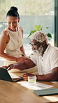 Laptop, documents and interracial couple in home for finance, investment or budget planning. Man, woman or discussion with computer, drink or paperwork for financial audit, bills or expenses in house