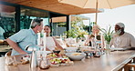 Friends, food and relax on patio with conversation, reunion and bonding together for summer holiday. Happy, mature people and talk outdoor in backyard with lunch meal, candle or vacation for wellness