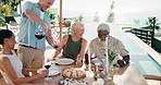 Wine, food and mature people on patio with summer holiday, conversation and lunch by swimming pool. Happy, friends and pour alcohol outdoor in backyard with meal, discussion and social gathering.