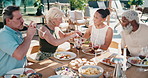 Summer, friends and charcuterie board on patio with wine, bonding together or relax on weekend break. Mature people, talk and lunch outdoor in backyard with alcohol drink, food platter and gathering.