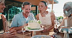 Woman, friends and blowing candles with birthday cake, wish and celebration for life milestone. Smile, mature people and applause at house with alcohol, dessert and socializing on special occasion
