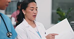 Doctor, team or walk with file in clinic for shift handover, health update or care planning on tech. Happy worker, women or folder in hallway for ward round, case discussion or test results on tablet