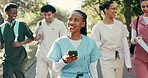 Woman, phone or medical student at university with smile, friends or check application for residency. Happy, person and walk outdoor at college with group, tech and thinking of healthcare course.