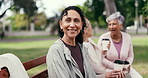 Face, friends and woman at park bench with smile, coffee break and laughing at reunion together. Mature person, group and hangout outdoor, funny humor and relax at social gathering with connection