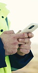 Hands, engineer and phone outdoor for construction, research and design approval for architecture. Person, inspector and typing at site with mobile, client inquiry and survey for building development