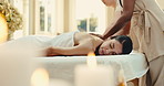 Spa, candles, and woman on bed for back massage with aromatherapy, relax or hospitality at resort. Hotel, luxury masseuse and mature person for stress relief, muscle reflexology or holistic detox