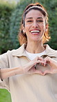 Fitness, face and woman with heart outdoor for wellness, exercise and health for cardio routine. Happy, portrait and mature person with emoji for fresh air, active lifestyle and smile for break