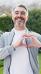 Fitness, face and man with heart outdoor for wellness, exercise and health for cardio routine. Happy, portrait and mature person smile with emoji for fresh air, active hobby and sports on break