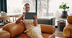 Woman, tablet and relax on couch with smile, online puzzle and down time hobby in living room. Mature person, technology and chill in home with ebook, media subscription and reading with scroll