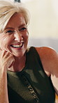 Laughing, home and happy woman talking with partner for funny joke, discussion or chat together. Mature, female person or couple with smile, humor or comedy for holiday or conversation in house