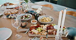 Party, food or charcuterie board on table with candles, sushi arrangement or meal setup at gathering. Celebration, nutrition or catering with platter, appetizer or snack selection in outdoor event.