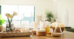 Candles, essential oil and spa setup for aromatherapy, cosmetic care and wellness at resort. Flowers, humidifier or fresh scent with pamper room interior, holistic therapy or treatment for selfcare