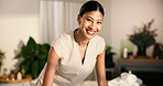 Face, woman and smile at spa with towel, massage preparation and cleanliness for hospitality. Masseuse, organizing and housekeeping at resort with fresh linen, arrangement and luxury treatment