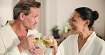 Couple, relax and tea in spa with cheers, bonding and detox for healthy relationship in luxury hotel. Happy, mature married people and toast at wellness retreat with warm drink, love and hospitality.