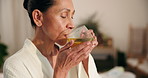 Woman, relax and drink tea at spa with detox, peace and hospitality at luxury hotel on weekend break. Mature person, rest and natural beverage at retreat for wellness, self care and calm staycation.