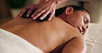 Woman, hot stone and back massage with hands for wellness, stress relief and self care at spa. Client, masseuse and warm rocks for deep tissue, muscle relaxation and reduce tension for bodycare 