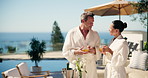 Couple, spa and outdoor at resort with tea, romantic vacation and bonding together on anniversary. Happy, married mature people and relax at wellness retreat with drink, luxury holiday or hospitality