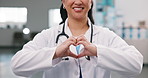 Hands, woman and doctor at hospital with heart, kindness and appreciation for medical support. Smile, employee and surgeon in clinic with love gesture, thank you and gratitude for healthcare services