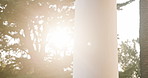 Pillar, sunshine and outdoor with trees for morning memory, holiday or getaway in tropical resort. Empty, structure and sunlight with lens flare of natural growth in vacation retreat or weekend villa
