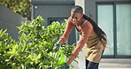 Watering, plants and woman with smile, backyard and gardening for green development and sustainable. Outdoor, gardener and black person with equipment, wellness and hydration for leaves at house
