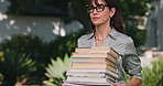 Professor, woman and walk at university with books, glasses and english course for higher education. Teacher, mature person and outdoor on college campus with knowledge, literature and resources.