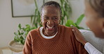 Laugh, talking and nurse with senior woman in home for comfort, bonding and understanding on sofa. Retirement, happy and caregiver with African patient for service, medical support and conversation