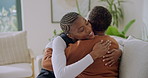 Happy, hug and caregiver with senior woman in home for comfort, bonding and connection on sofa. Retirement, smile and nurse with African patient embrace for affection, medical support and trust