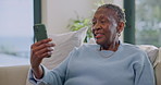 Video call, happy and senior woman with phone for talking, connection and online chat for contact. Home, sofa and elderly African person on cellphone for conversation, speaking and communication