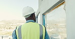 Back, man and engineer at site for construction, inspection and building progress for expansion. Male person, contractor or walking outdoor for supervision, quality assurance and architecture project