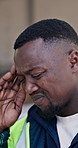 Architect, man and headache with stress on construction site for building mistake or overworked. Frustrated, male person or civil engineer with migraine or fatigue for project deadline or pressure