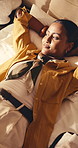 Calm, woman and relax in hotel room with vacation, travel fatigue or reflection for peaceful getaway. Above, person and holiday in accommodation with jet lag exhaustion, thinking and rest on bed.