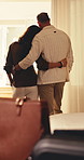 Back, couple and window at hotel room for travel, guest arrival and check in for anniversary holiday. People, embrace or outdoor view at resort with luggage, partner affection and vacation staycation