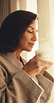 Woman, rest and smell coffee in hotel room with peaceful morning, reflection and downtime on holiday. Calm, mature person and thinking by resort window with tea aroma, vacation and weekend getaway.