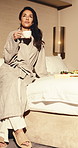 Woman, relax and coffee in hotel room with breakfast, luxury vacation and hospitality for wellness. Calm, mature person and drink tea in accommodation with morning meal, peaceful trip and  holiday.