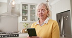 Texting, online and senior woman with phone, kitchen and communication with contact on social media. Typing, message and old person with mobile app, internet connection and chatting on web in house