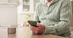 Hands, texting and senior person with phone, kitchen and communication with contact on social media. Typing, message and pensioner with mobile app, internet connection and chatting on web in house