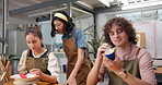 Teacher, people and painting in art class with ceramics, explain design and guidance for technique. Instructor, group and teach in pottery workshop with paintbrush, discussion and tips for creativity