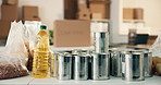 Office, food and donation on table for charity, canned good and non profit of community outreach. Empty, workplace and groceries with boxes for collection, pantry staple and aid package for welfare