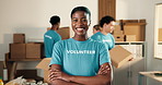 Woman, volunteer and face in NGO with arms crossed, charity preparation and outreach program. Coordinator, confident and happy at centre for food drive, social responsibility or donations for project