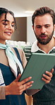 People, owner and review at cafe with tablet, discussion and inventory check for menu update. Smile, team and talking at coffee shop with digital, stock checklist and increase pricing for hospitality