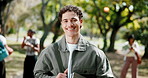 Face, man and happy at college with bag, positive attitude or aspiration for higher education degree. Student, person and smile outdoor at university with textbook, pride or learning with scholarship