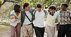 Happy, friends or university student in park with walk, group hug or connection in higher education. Diversity, laughing or people with embrace, peer bonding or college support in study opportunity.