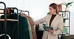 Fashion, tablet and woman in clothing store for stock management, online sales or small business. Tech, person and boutique entrepreneur with rack for pricing check, style or verify inventory level