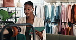 Fashion, tablet or woman with clothing rack for stock, verify size or review in small business. Tech, black person or inventory management in boutique with sales check, retail style or update catalog