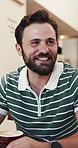 Laugh, friends and man in coffee shop with chat, funny conversation or humor connection in cafe. Smile, gossip or person in restaurant with warm beverage, joke reaction or happy moment with hangout.